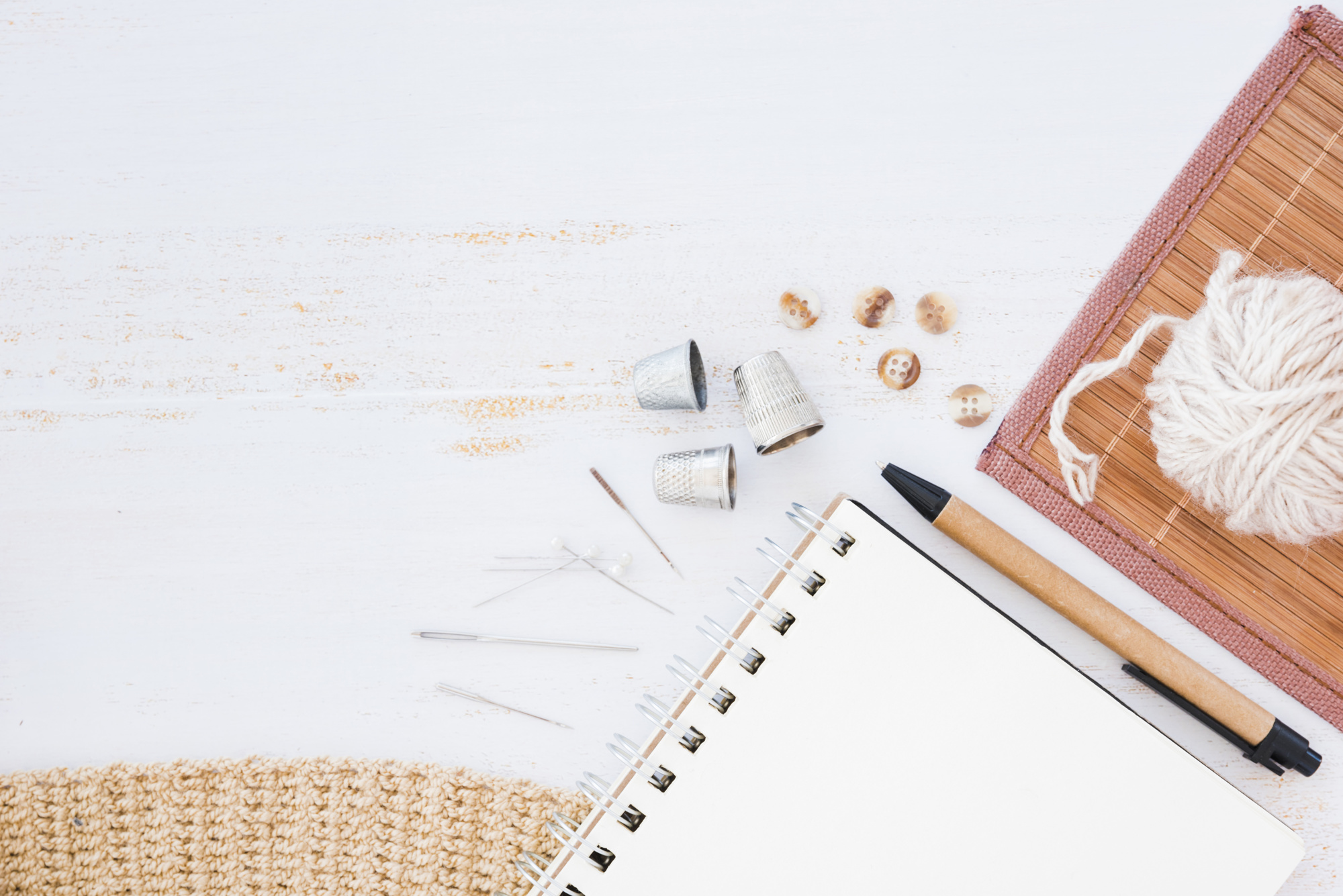 workbench with needle, thread and notes